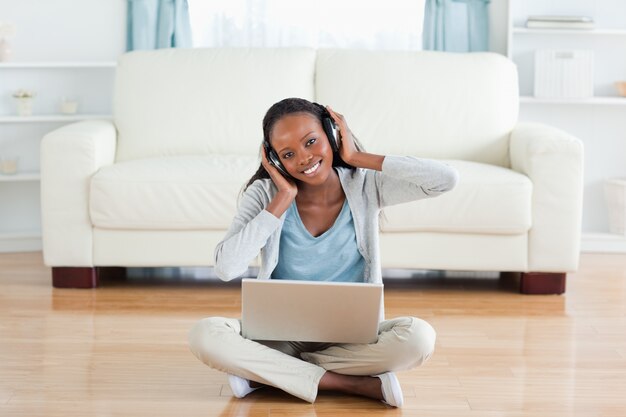 Woman sitting on the floor enjoying music