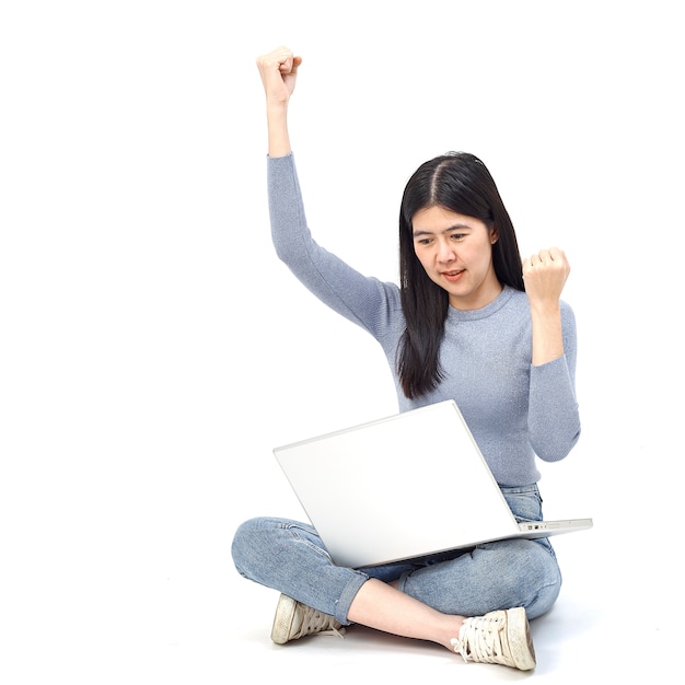 Woman sitting floor holding laptop