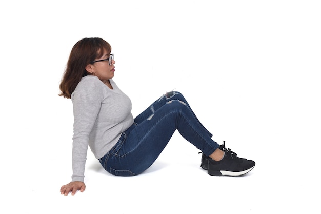 Woman sitting on the floor on white background