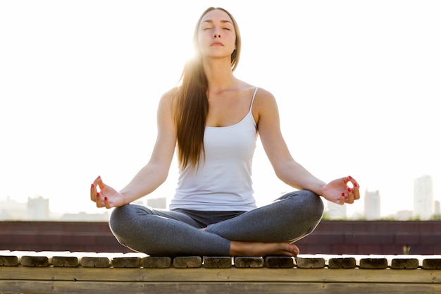 Woman sitting on the floor with crossed legs