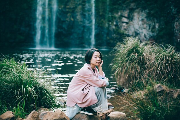 Woman sitting in forest