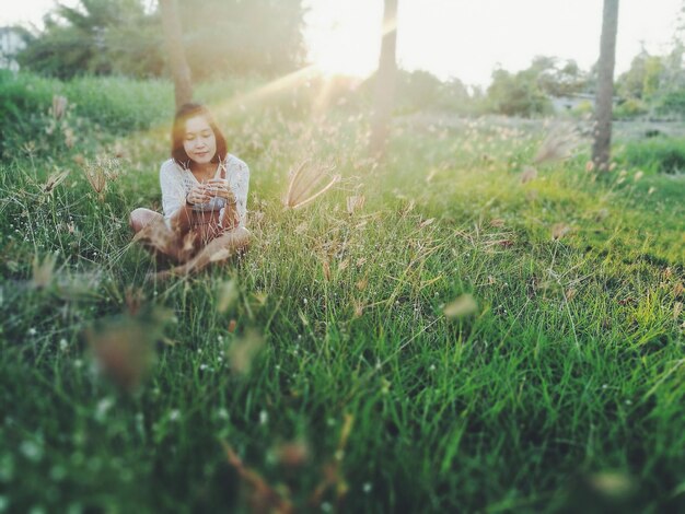 Photo woman sitting on grass in the park