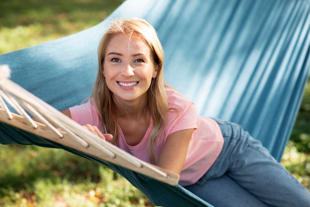 Woman sitting in hammock outdoors