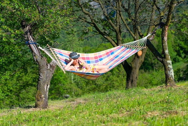 Woman sitting on hammock