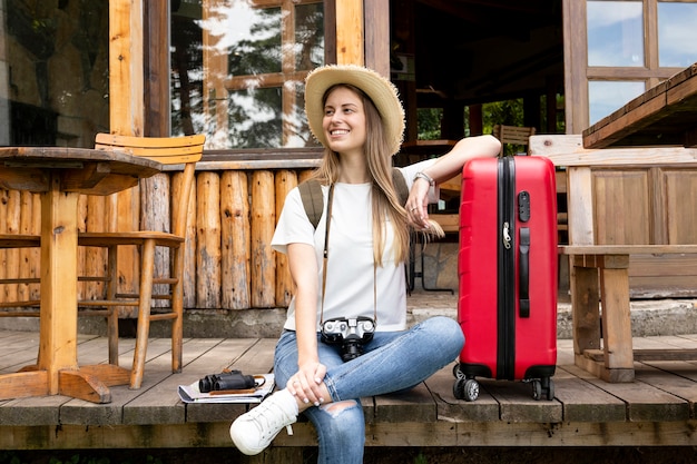 Woman sitting next to her luggage