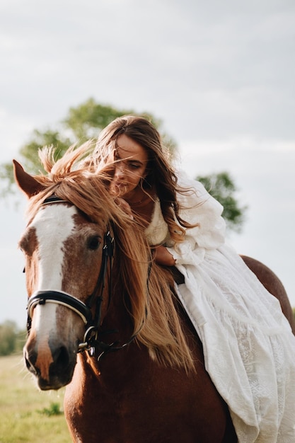 Woman sitting on horse against sky
