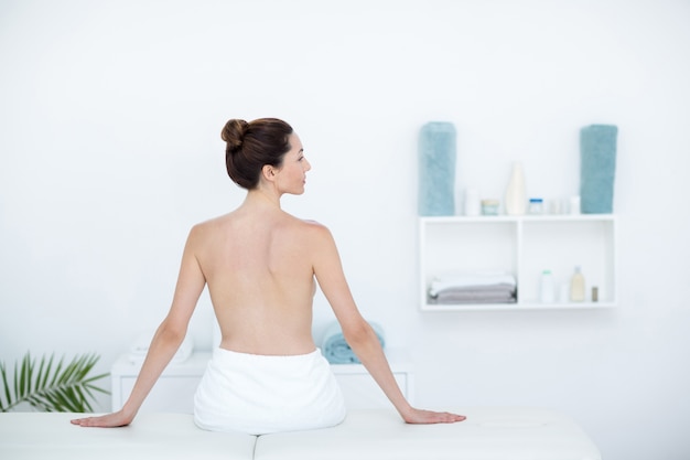 Woman sitting on massage table