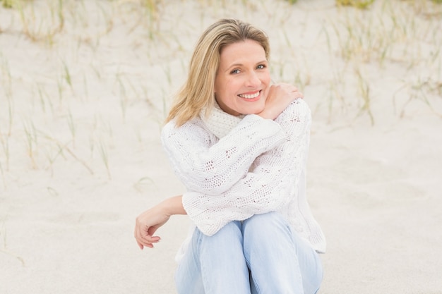 Woman sitting near the sandy hill