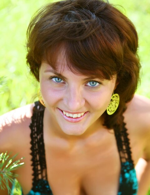 Woman sitting outdoors smiling