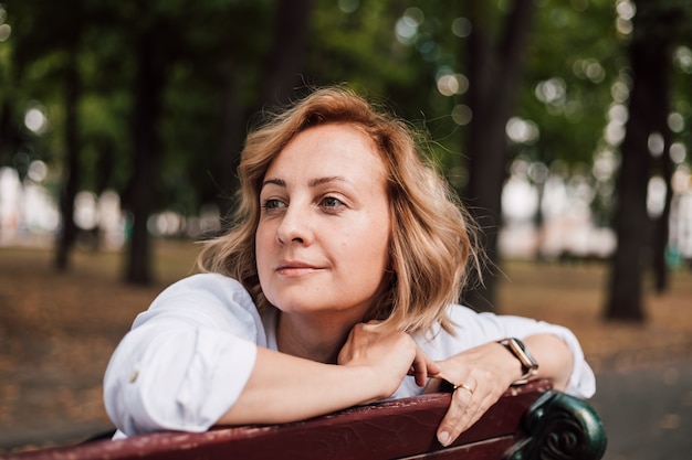 A woman sitting on a park bench