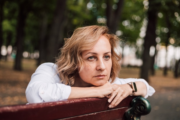 A woman sitting on a park bench