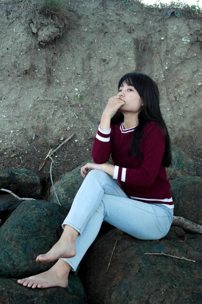 Woman sitting on rock