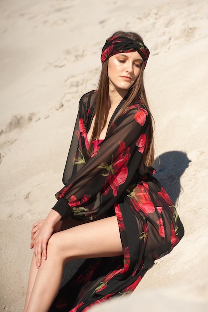 Woman sitting on the sand in the desert