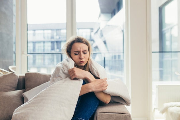  woman sitting on sofa at home depressed girl is having a hard time with stress