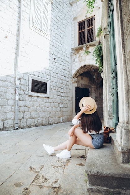 Woman sitting on stairs outside at summer day