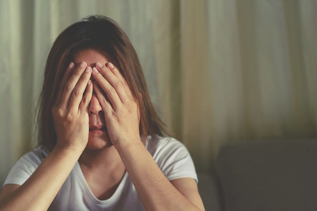 A woman sitting stressed, depressed, insomnia who broke up with her boyfriend.