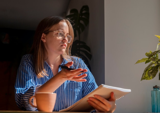 Woman sitting at table in cafe explaining smth ro smb talking business advisor