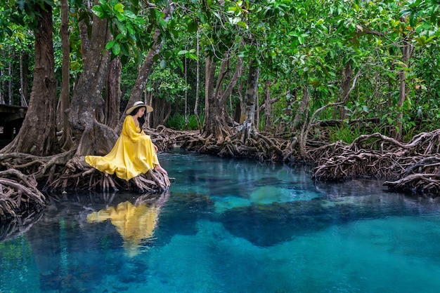 Woman sitting on Tapom in Krabi, Thailand.