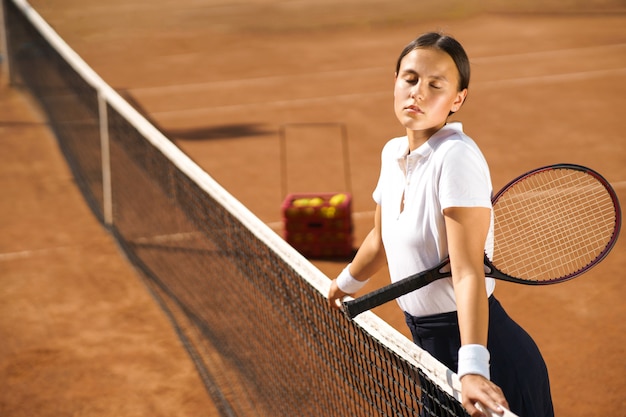 A woman sitting on the tennis court