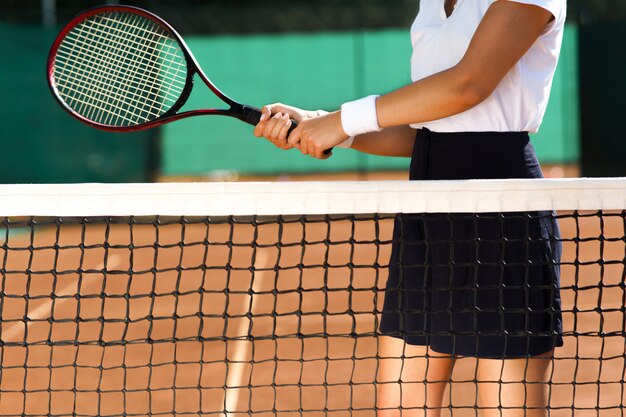 A woman sitting on the tennis court