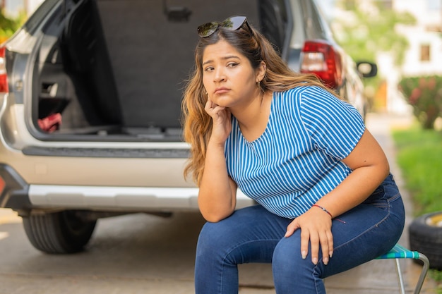 Woman sitting waiting for the tow truck