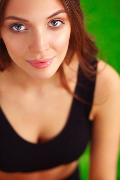 Woman sitting with crossed legs on the green grass