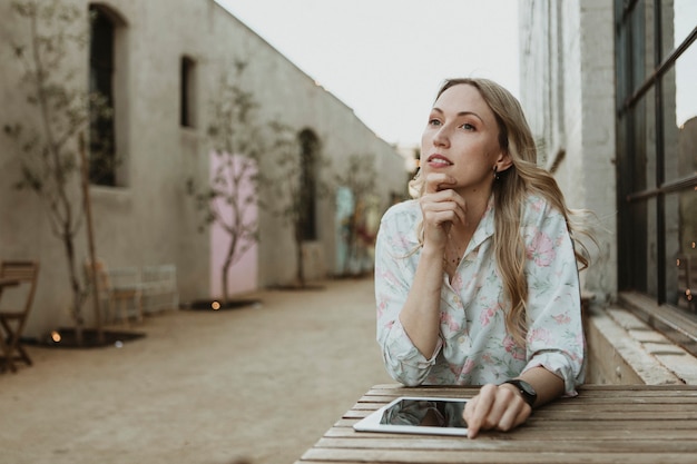 Woman sitting with a digital tablet