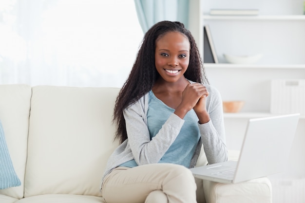 Woman sitting with her laptop on sofa