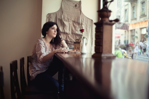 Woman sitting on a wooden table