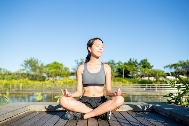 Woman sitting in yoga pose at park