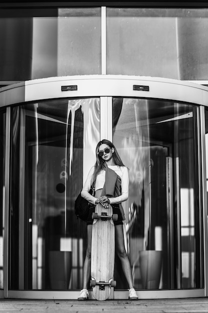 Woman on a skateboard in the city beautiful contrasting black and white photo of a woman riding