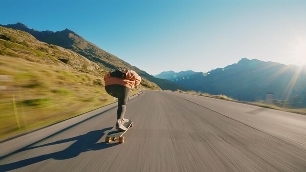 Woman skateboarding and making tricks between the curves on a mountain pass