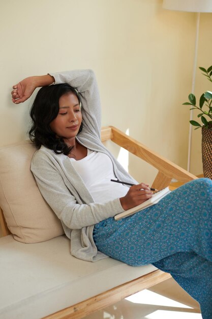 Woman Sketching in Notepad