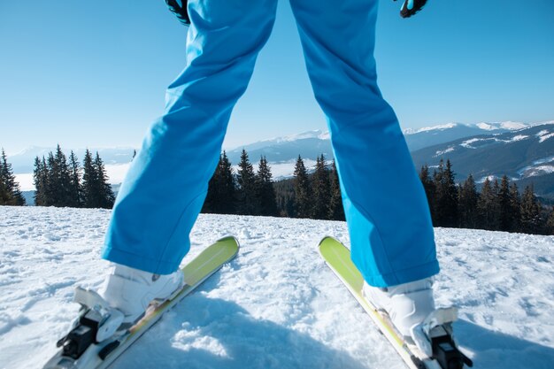 Woman skier portrait with ski on the top of the mountains winter vacation