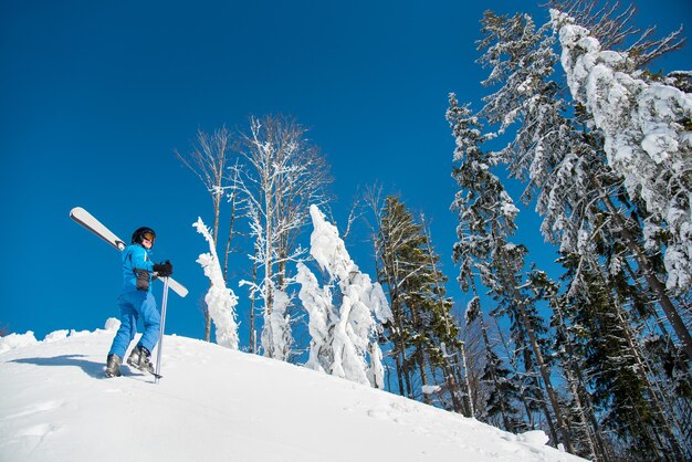 Woman skier on slope at ski resort in winter