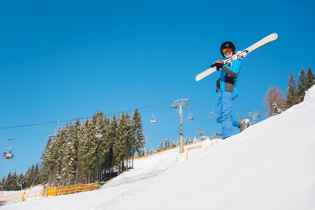 Woman skier on slope at ski resort in winter