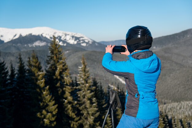 Woman skier on slope at ski resort in winter