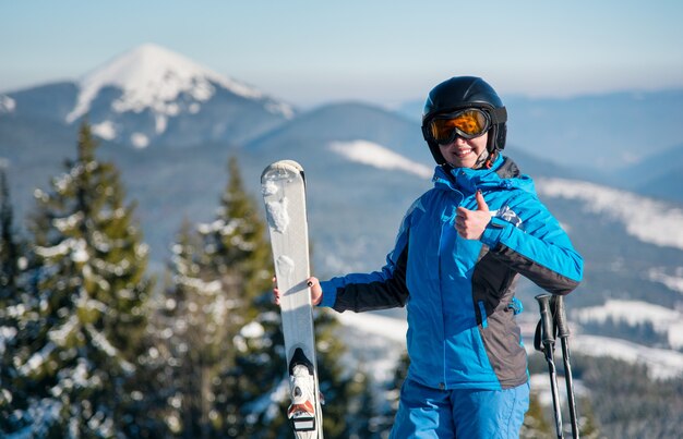 Woman skier on slope at ski resort in winter