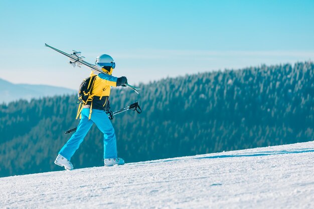 배경에 겨울 슬로프 산에서 스키를 타고 여자
