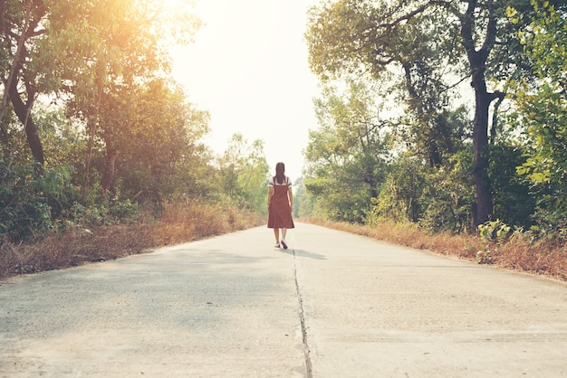 Woman skirt and sneaker shoes Walking on the road and park