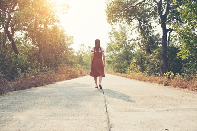 Woman skirt and sneaker shoes Walking on the road and park