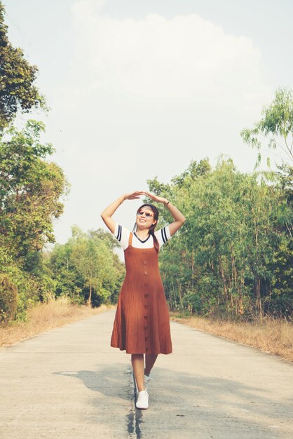 Woman skirt and sneaker shoes Walking on the road and park