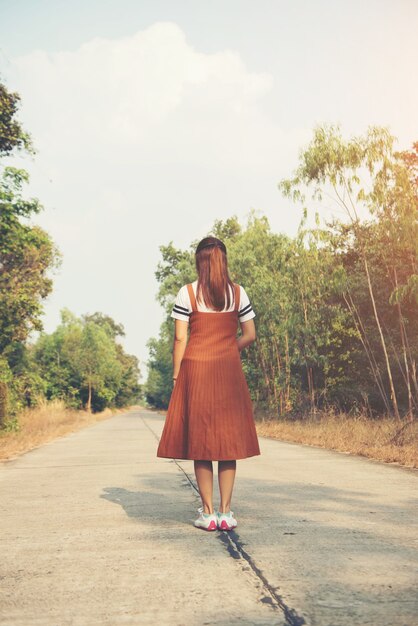 Woman skirt and sneaker shoes Walking on the road and park