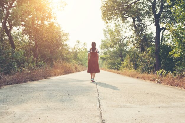 Woman skirt and sneaker shoes Walking on the road and park