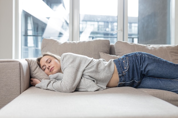  woman sleep resting at home on couch after a hard days