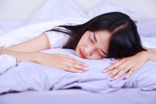 woman sleeping on bed in the bedroom