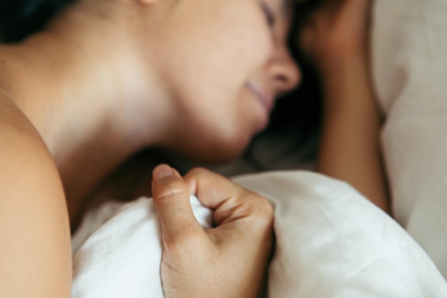 Woman sleeping in bed close up blurred