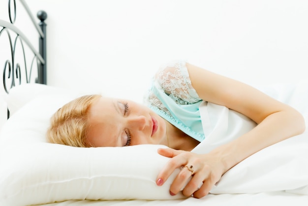 woman sleeping on white sheet 