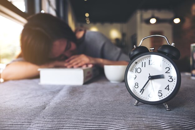 Foto donna che dorme con la sveglia