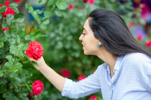 Woman smell in rose in street